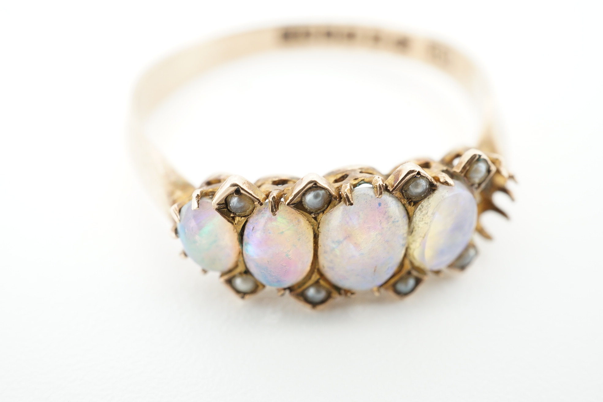 An early 20th century 9ct gold and opal cluster cluster set ring, size M, a 9ct and four(ex five) stone set opal half hoop ring and an 18ct and five stone diamond set half hoop ring. Condition - poor to fair